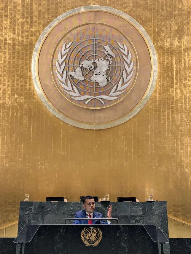 Photo of Ehab James at the podium of the United Nations.